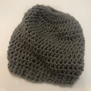 Gray knitted beanie with ponytail hole.